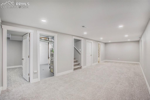 basement featuring light colored carpet