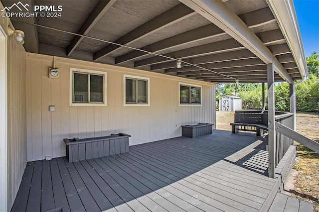 wooden terrace with a storage shed