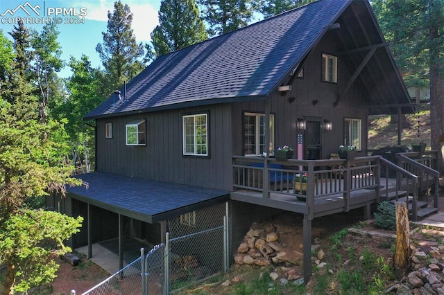 rear view of house featuring a deck