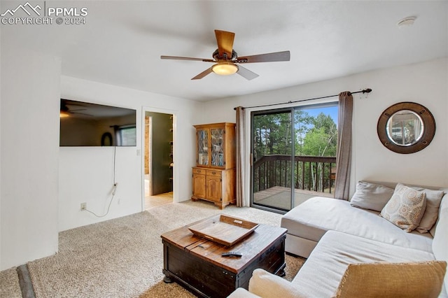 carpeted living room featuring ceiling fan