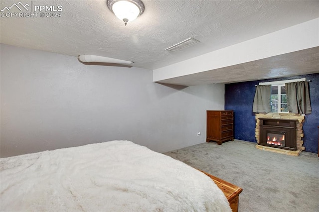 bedroom with carpet floors and a textured ceiling