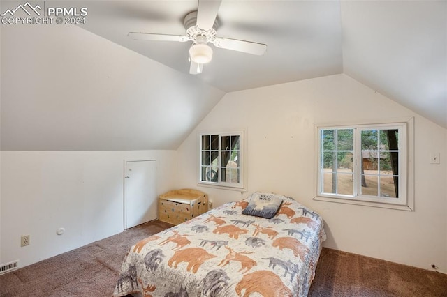 carpeted bedroom with ceiling fan and vaulted ceiling