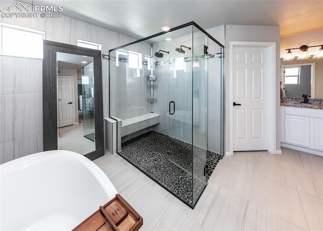 bathroom featuring vanity and plus walk in shower