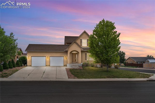 view of front of property with a lawn and a garage