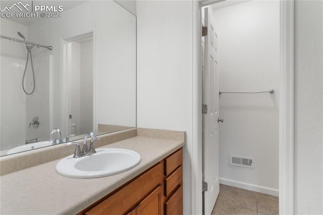 bathroom with tile patterned floors, vanity, and tub / shower combination