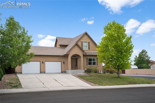 view of front of home featuring a front lawn and a garage