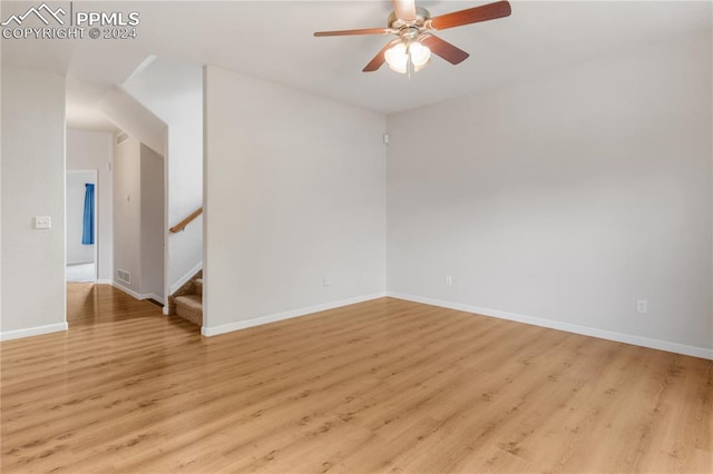 empty room with ceiling fan and light wood-type flooring