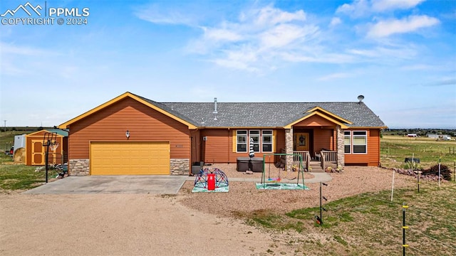 view of front of house with a storage unit and a garage