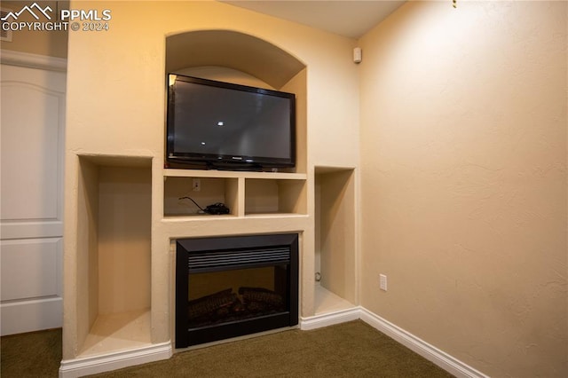 unfurnished living room featuring dark carpet