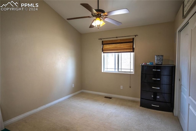 unfurnished bedroom featuring light carpet and ceiling fan