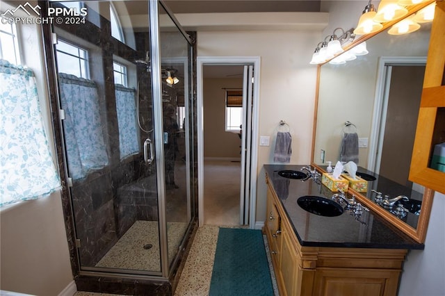 bathroom featuring vanity, a healthy amount of sunlight, and an enclosed shower