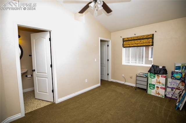 misc room with dark colored carpet, vaulted ceiling with beams, and ceiling fan