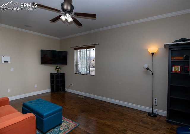 living room featuring dark hardwood / wood-style floors, ceiling fan, and crown molding