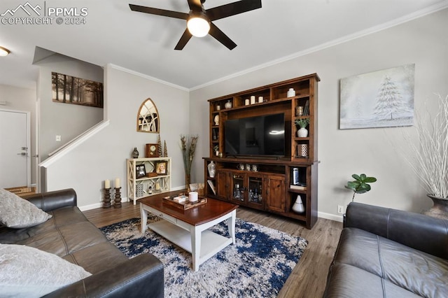 living room featuring hardwood / wood-style flooring, ceiling fan, and crown molding