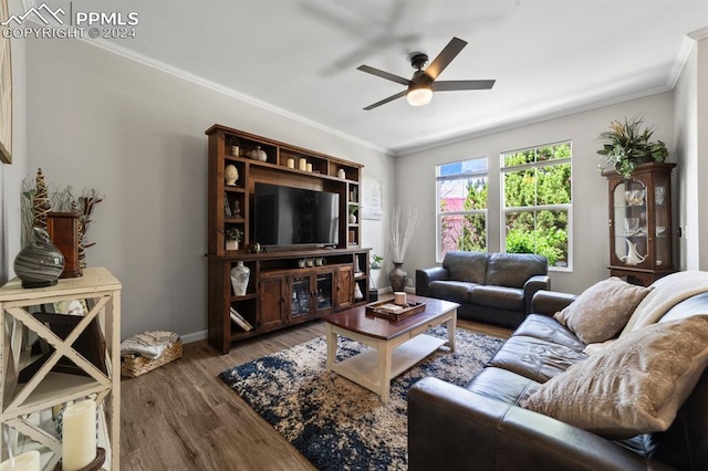 living room with hardwood / wood-style floors, ceiling fan, and crown molding