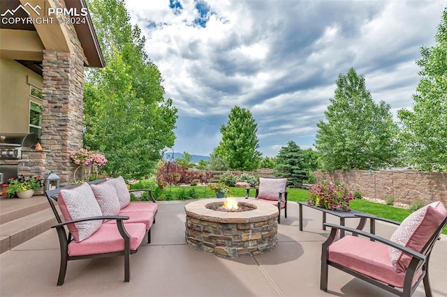 view of patio / terrace featuring an outdoor living space with a fire pit