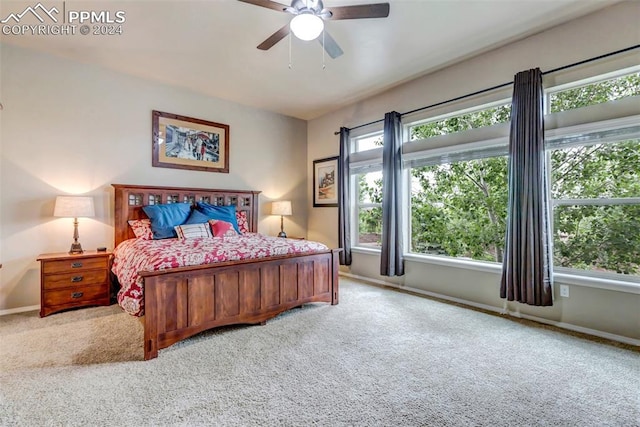 bedroom with carpet, ceiling fan, and multiple windows