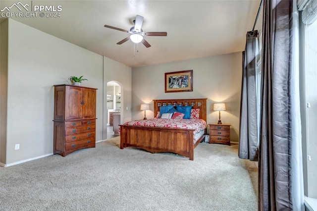 carpeted bedroom with connected bathroom and ceiling fan