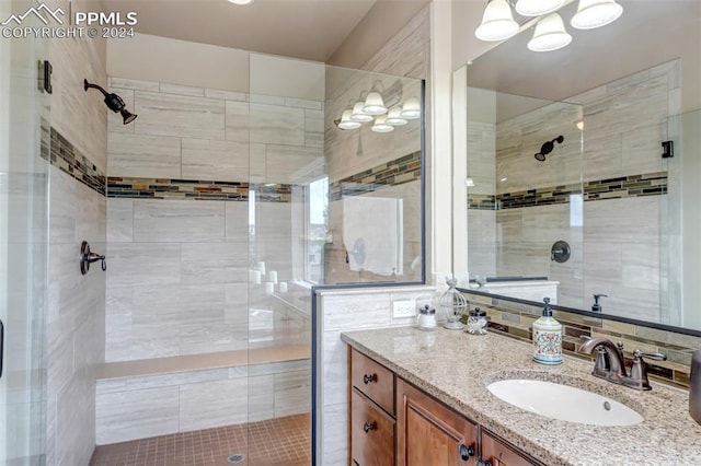 bathroom featuring vanity and an enclosed shower