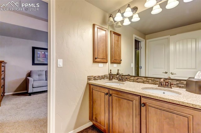 bathroom featuring vanity and backsplash