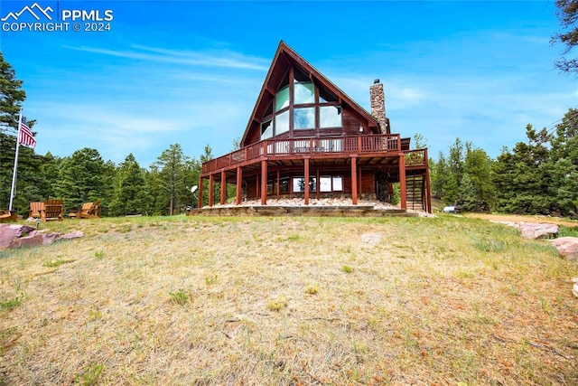 rear view of house featuring a deck