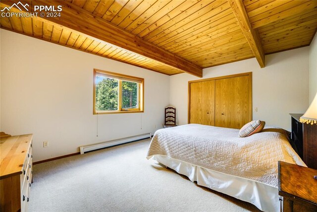 carpeted bedroom featuring a baseboard heating unit, a closet, wood ceiling, and beamed ceiling