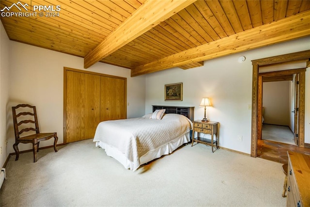 bedroom with carpet flooring, beamed ceiling, a closet, and wood ceiling