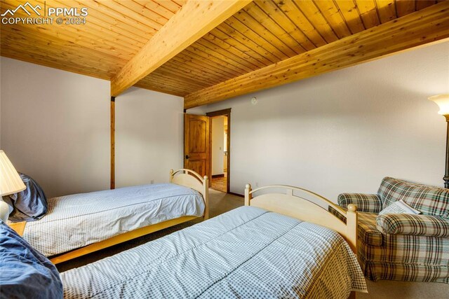 bedroom featuring beamed ceiling and wood ceiling