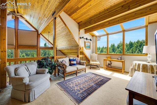 carpeted living room with vaulted ceiling with beams, ceiling fan, and wooden ceiling