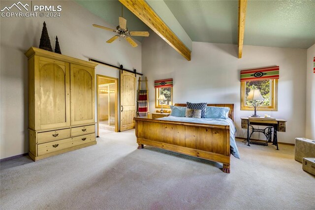 carpeted bedroom featuring vaulted ceiling with beams, ensuite bathroom, a barn door, and ceiling fan