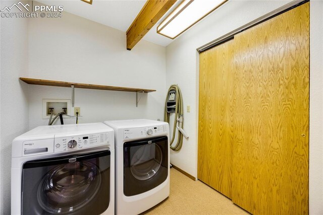 washroom with hookup for a washing machine and washing machine and clothes dryer