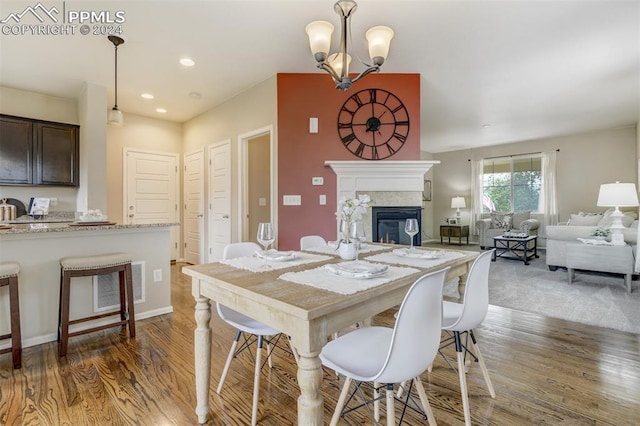 dining space with dark hardwood / wood-style floors and a chandelier