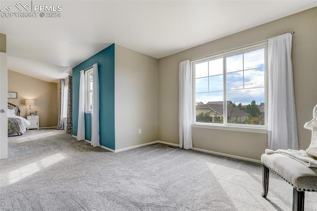 bedroom featuring vaulted ceiling and light colored carpet