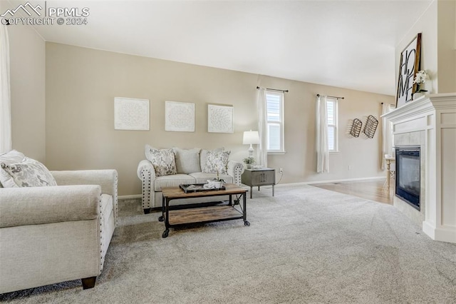 carpeted living room with a tiled fireplace