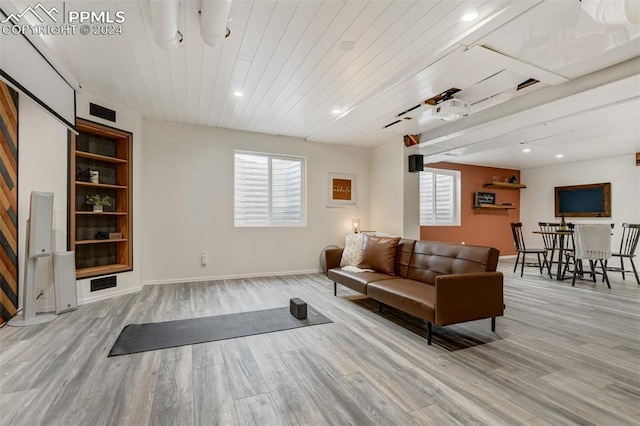 living room featuring wood ceiling, light hardwood / wood-style floors, and a healthy amount of sunlight