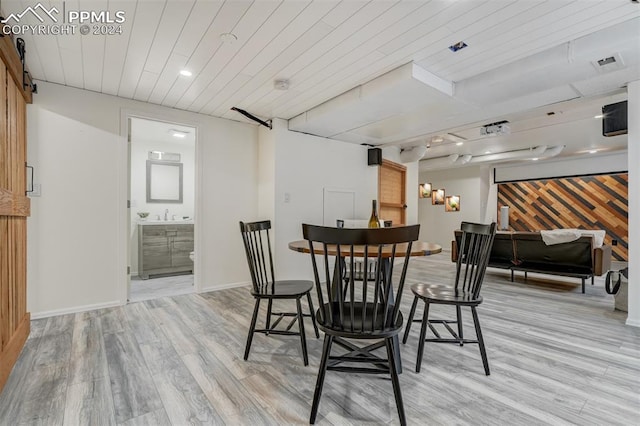 dining room featuring wooden ceiling and light wood-type flooring