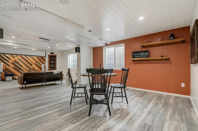 dining area with wood ceiling and light hardwood / wood-style flooring