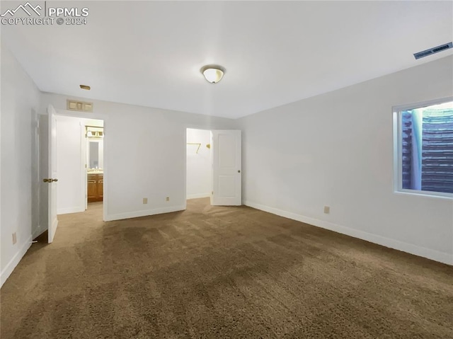 unfurnished bedroom featuring dark carpet