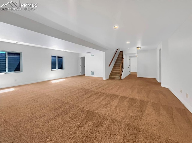 unfurnished living room featuring carpet flooring