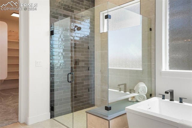 bathroom featuring tile patterned floors, separate shower and tub, and sink