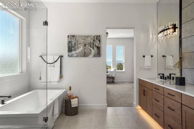 bathroom with tile patterned flooring, vanity, and a bath