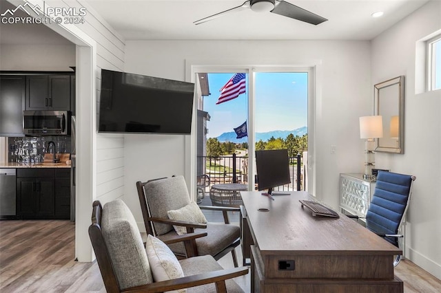 office area with ceiling fan, sink, a healthy amount of sunlight, and light hardwood / wood-style floors