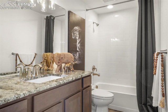 full bathroom with vanity, shower / bathtub combination with curtain, and toilet