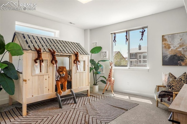 sitting room featuring carpet flooring and a healthy amount of sunlight