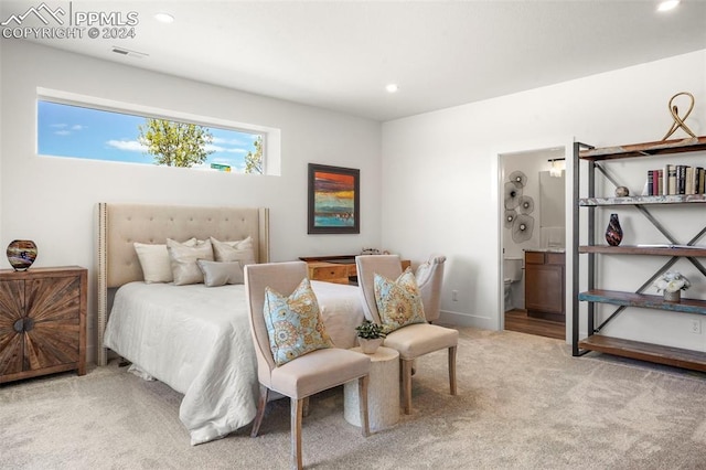 carpeted bedroom featuring connected bathroom