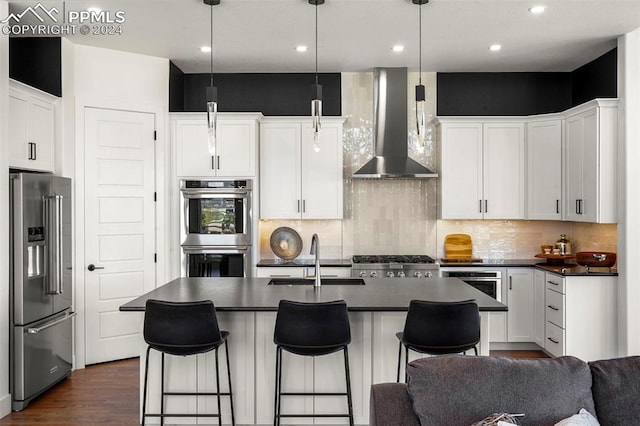 kitchen featuring white cabinets, sink, wall chimney exhaust hood, and stainless steel appliances