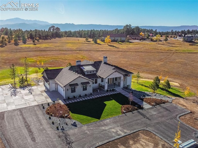 drone / aerial view featuring a mountain view and a rural view