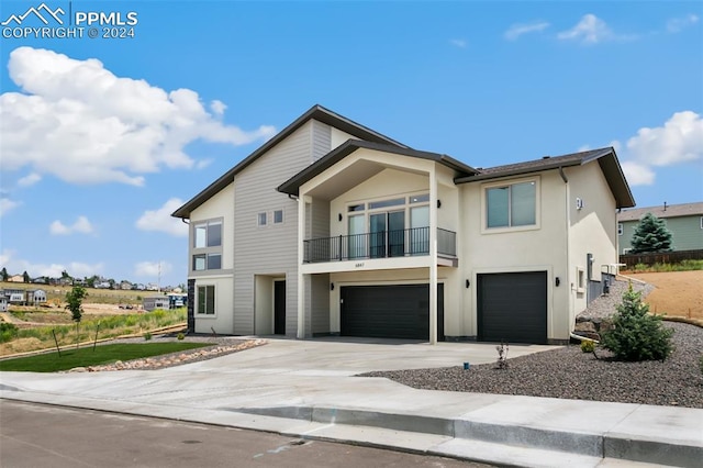 view of front of property with a garage and a balcony