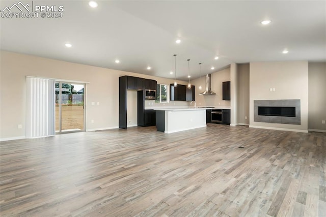 unfurnished living room featuring sink and light wood-type flooring