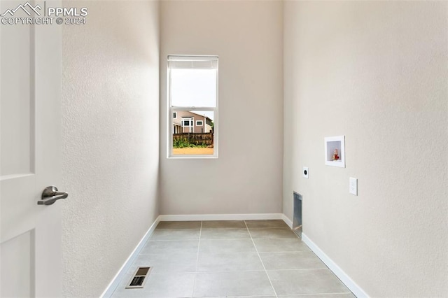 washroom with washer hookup, electric dryer hookup, and light tile floors